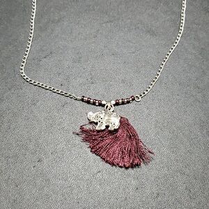 Silver tone elephant and tassel necklace